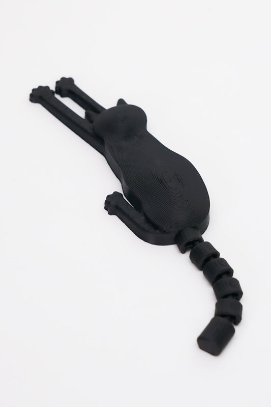 3D printed μαύρης γάτας μαγνητάκι με flexy ουρά σε λευκό φόντο