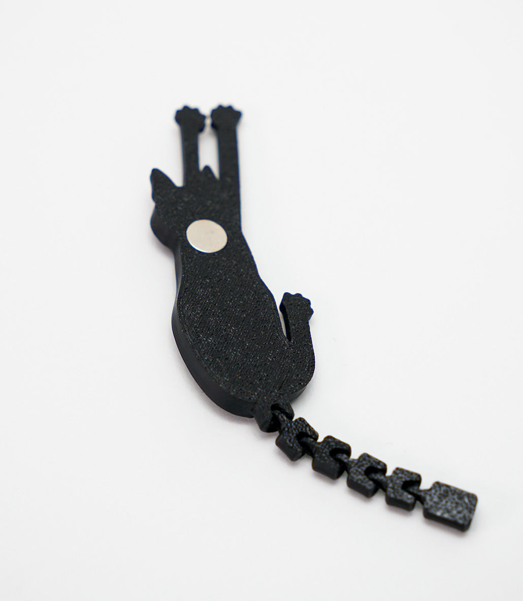 Back view of a 3D printed flexy cat magnet showing the built-in round magnet