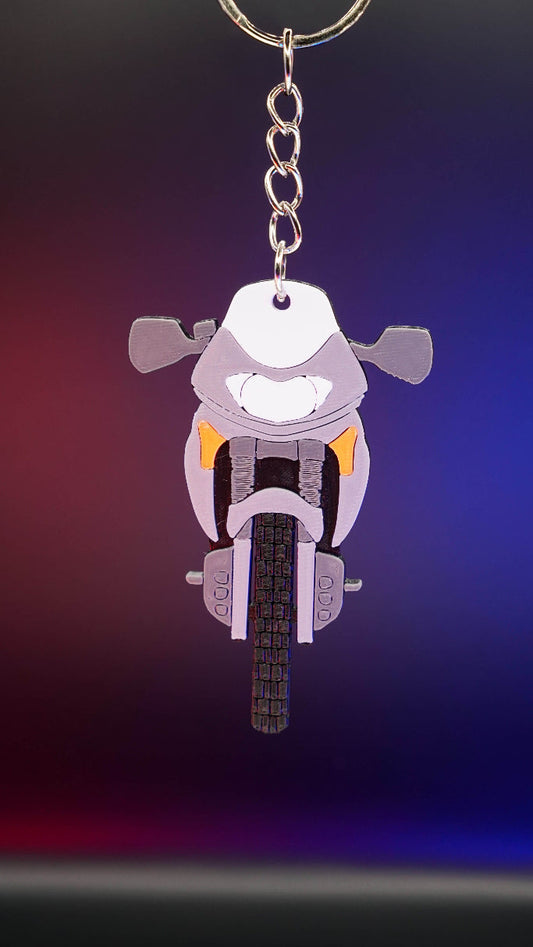 3D printed μπρελόκ Honda Transalp 650 σε κάθετη hero λήψη με πολύχρωμο φωτισμό φόντου